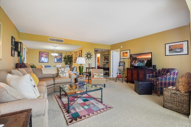 living room featuring light carpet and an inviting chandelier