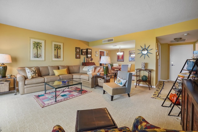 living room with carpet and a chandelier