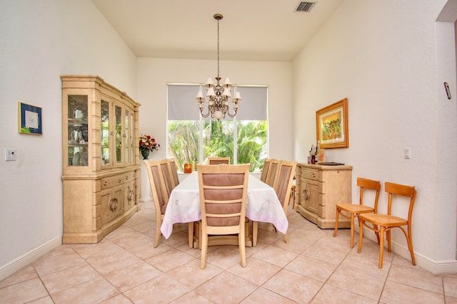 tiled dining space featuring an inviting chandelier