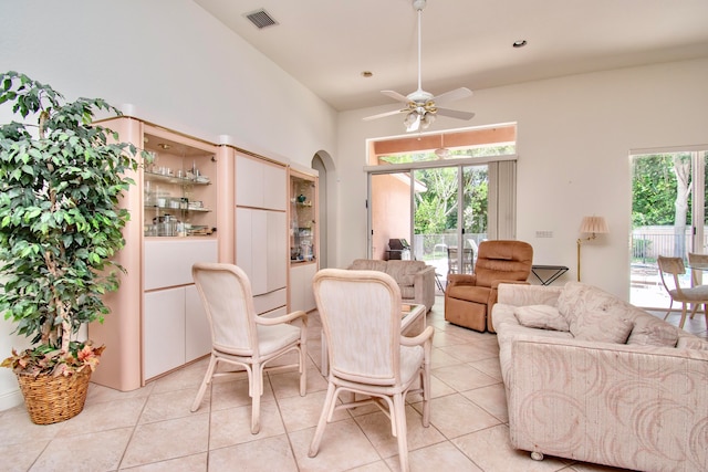 tiled dining space featuring ceiling fan, a wealth of natural light, and vaulted ceiling