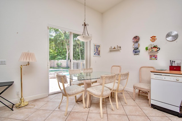 tiled dining room featuring high vaulted ceiling