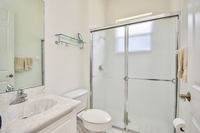 bathroom with vanity, toilet, and walk in shower