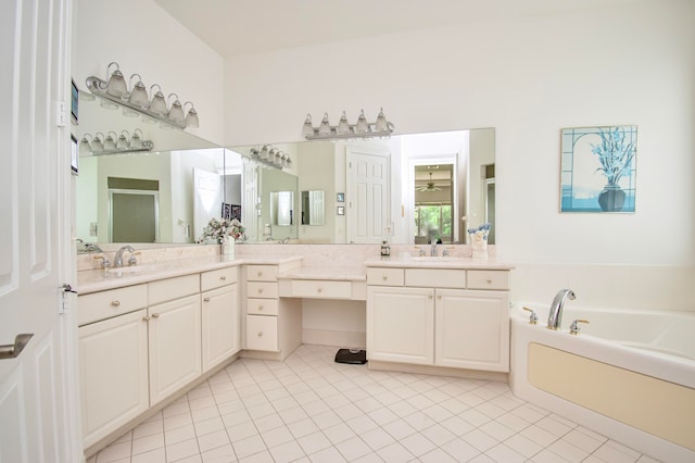 bathroom featuring tile patterned floors, vanity, and a tub