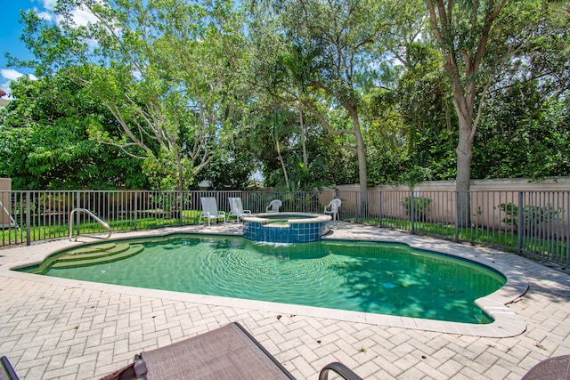 view of pool with an in ground hot tub and a patio