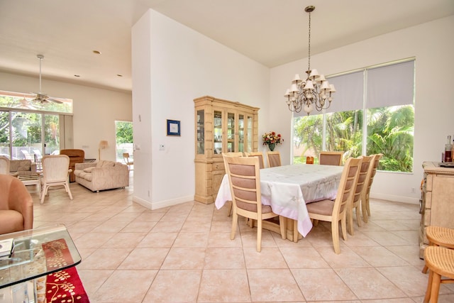 tiled dining area featuring ceiling fan with notable chandelier