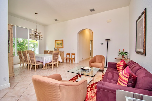 living room with light tile patterned floors and a notable chandelier