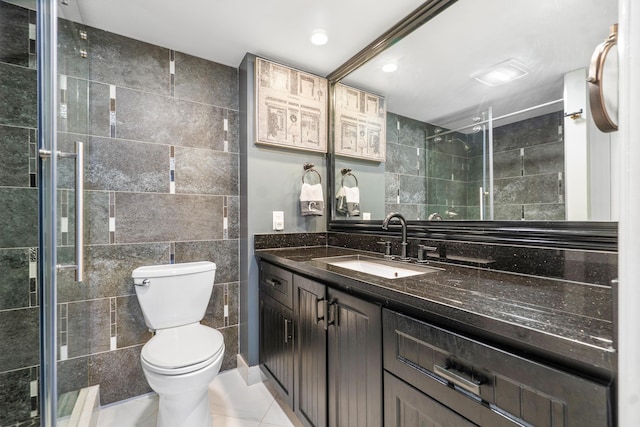 bathroom featuring tile walls, vanity, tile patterned flooring, and an enclosed shower