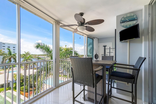 sunroom / solarium featuring ceiling fan