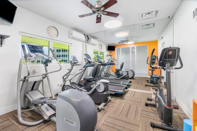 exercise room featuring ceiling fan and a wall mounted AC