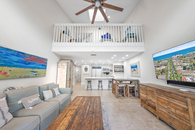 tiled living room with high vaulted ceiling and ceiling fan