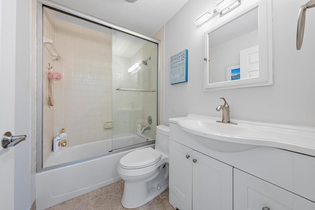 full bathroom with shower / bath combination with glass door, vanity, tile patterned floors, and toilet