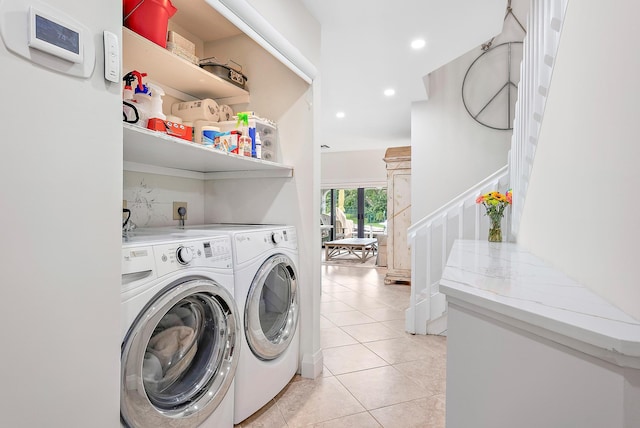 laundry room featuring light tile patterned flooring and washer and clothes dryer