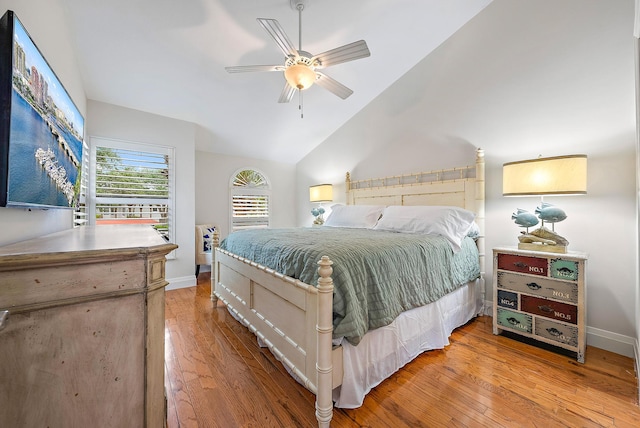 bedroom with light wood-type flooring, ceiling fan, and lofted ceiling