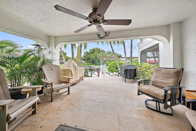 view of patio / terrace featuring ceiling fan and grilling area