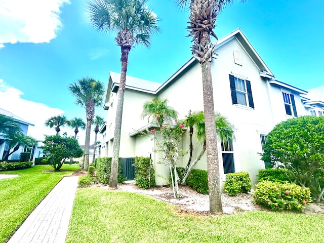 view of home's exterior with a yard