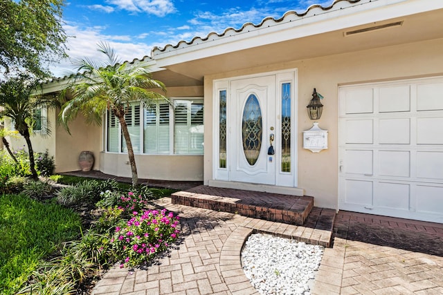 view of exterior entry featuring a garage