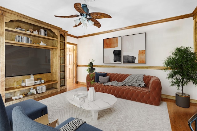 living room featuring hardwood / wood-style floors, ceiling fan, and ornamental molding