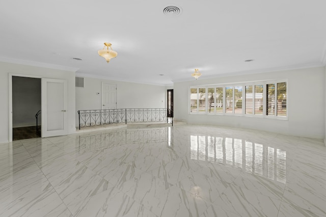 spare room featuring marble finish floor, visible vents, and crown molding