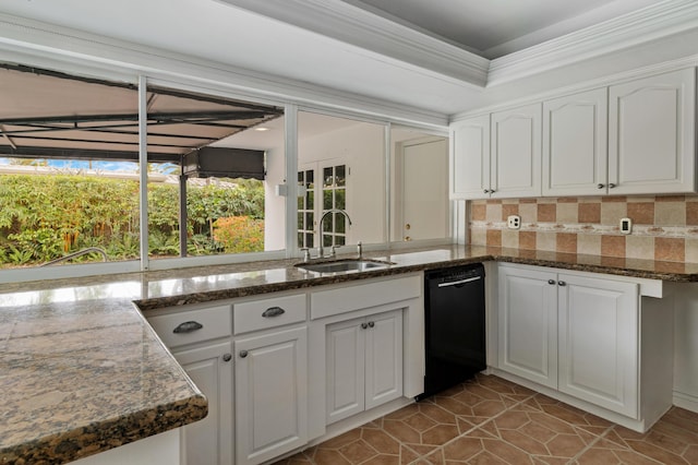 kitchen with black dishwasher, a sink, and white cabinetry