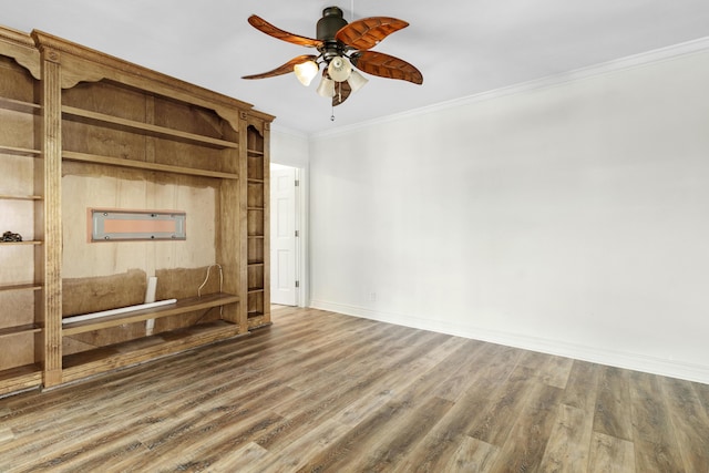 interior space featuring baseboards, ornamental molding, ceiling fan, and wood finished floors