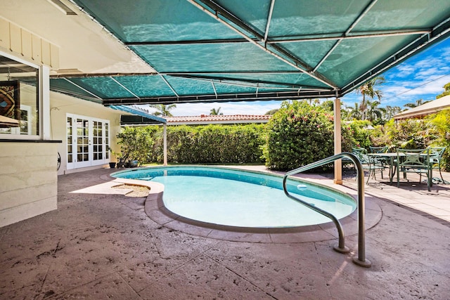 view of pool with a patio and french doors