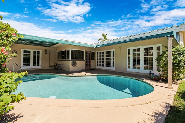 view of pool with a patio area and french doors