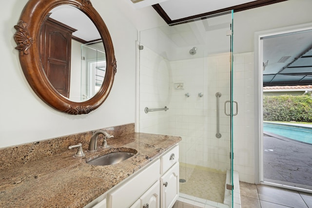 full bathroom featuring a shower stall, tile patterned flooring, and vanity