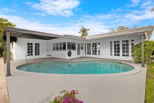 pool with a patio and french doors