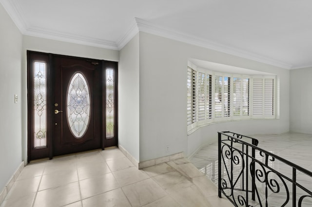 foyer entrance featuring crown molding and baseboards