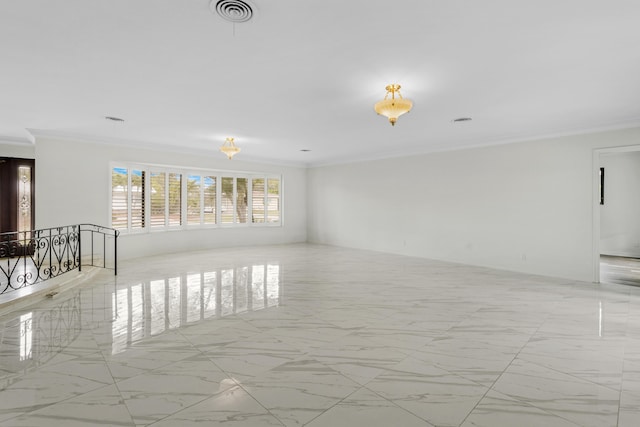 spare room featuring marble finish floor, visible vents, and crown molding