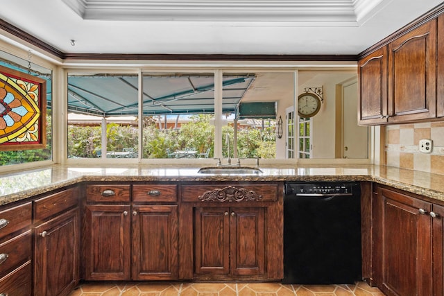 kitchen with plenty of natural light, tasteful backsplash, dishwasher, and light stone counters