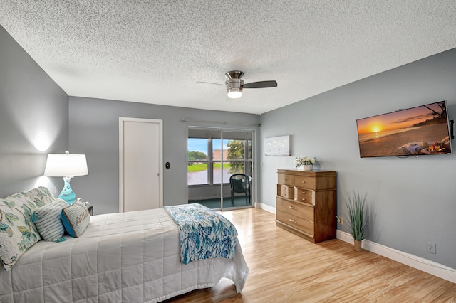 bedroom featuring ceiling fan, a textured ceiling, and light wood-type flooring