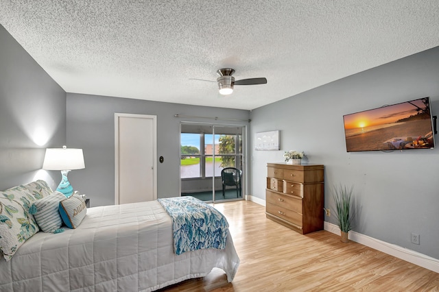 bedroom featuring ceiling fan, access to outside, a textured ceiling, and light wood-type flooring