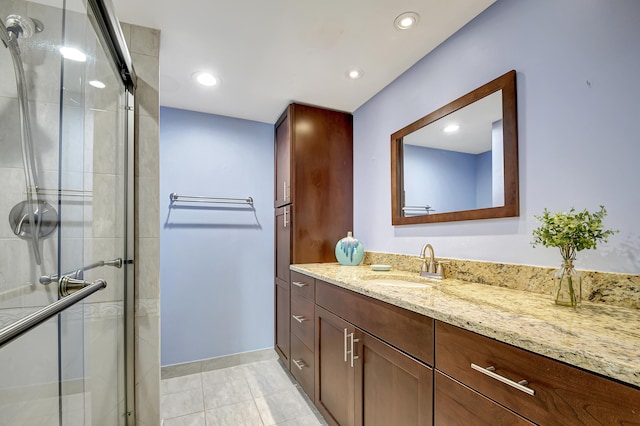 bathroom with tile floors, walk in shower, and vanity