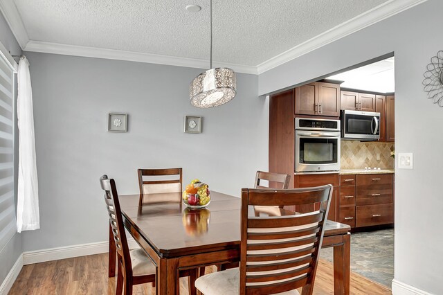 dining room featuring ornamental molding and hardwood / wood-style flooring