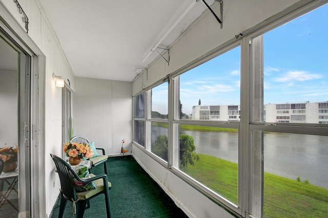 unfurnished sunroom featuring a wealth of natural light and a water view