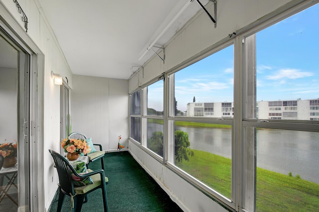 sunroom / solarium with a water view