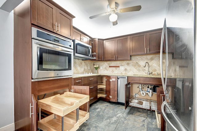 kitchen featuring tile flooring, stainless steel appliances, light stone counters, backsplash, and ceiling fan