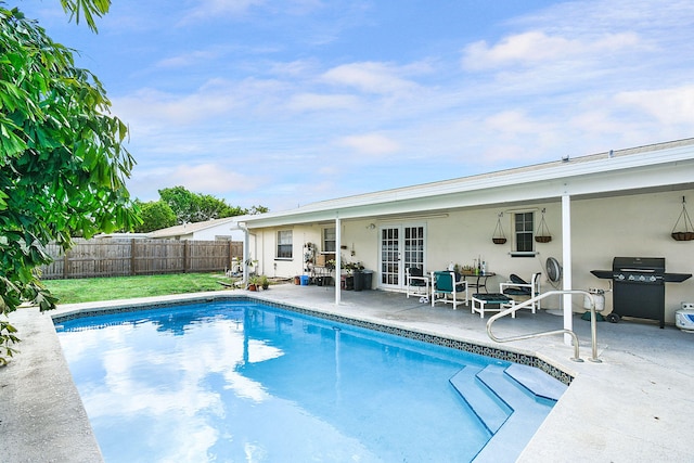 view of pool featuring a grill, a patio area, and french doors