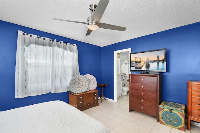 tiled bedroom with ceiling fan, a textured ceiling, and connected bathroom