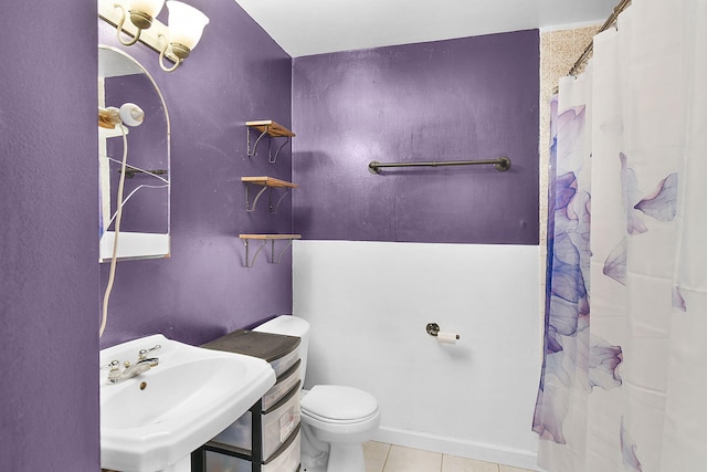 bathroom with toilet, a shower with shower curtain, tile patterned floors, and sink