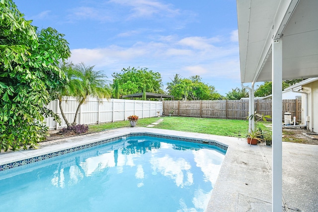 view of pool featuring a lawn