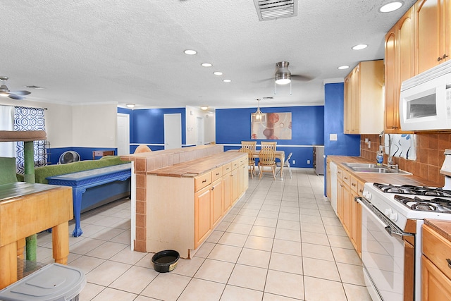 kitchen with white appliances, ceiling fan, light brown cabinets, hanging light fixtures, and light tile patterned flooring