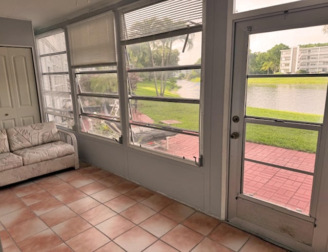 sunroom / solarium featuring a water view