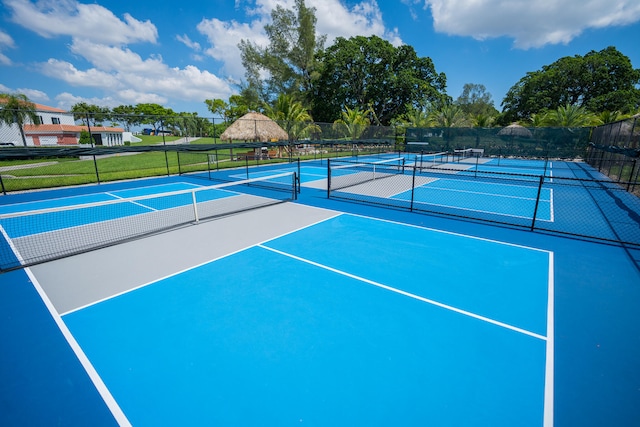 view of tennis court featuring basketball hoop