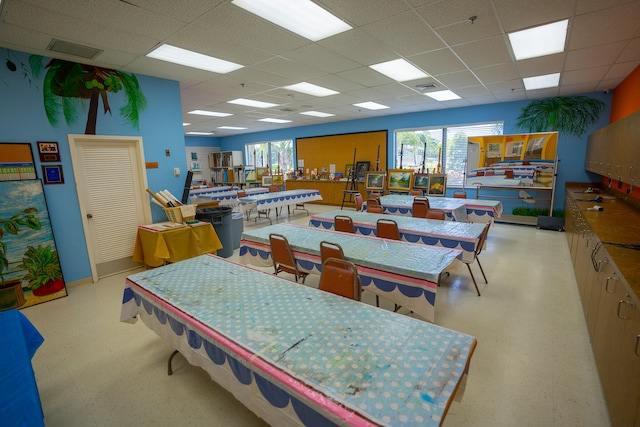 dining area with a paneled ceiling