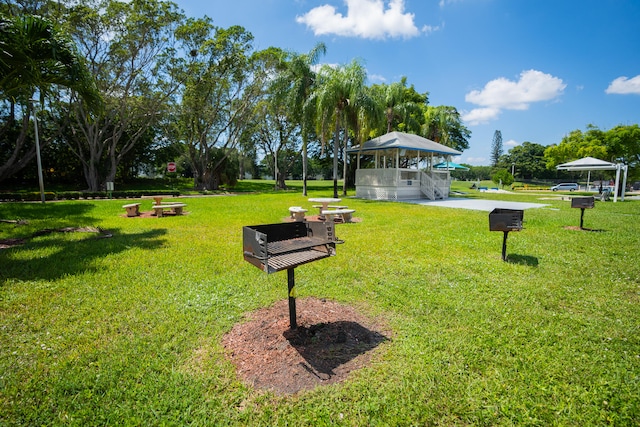 view of property's community with a patio, a lawn, and a gazebo