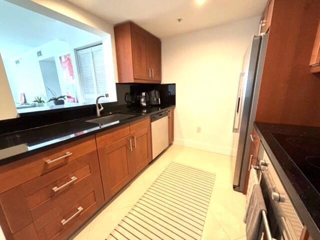 kitchen featuring sink, light tile patterned floors, and stainless steel appliances