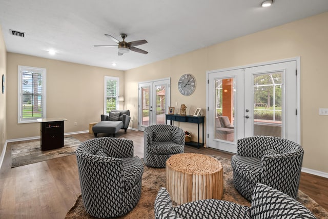 living area featuring french doors, visible vents, and wood finished floors