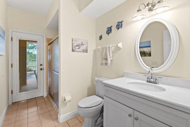 full bathroom with toilet, a stall shower, vanity, tile patterned flooring, and baseboards